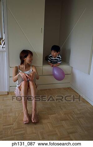 Stock Photo - Asian mother and son talking. Fotosearch