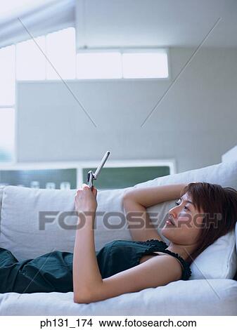Asian woman using a cell phone View Large Photo Image Picture - Asian woman using a cell phone. Fotosearch