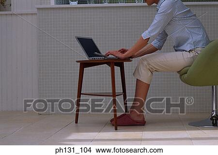Asian woman using a laptop View Large Photo Image Picture - Asian woman using a laptop. Fotosearch