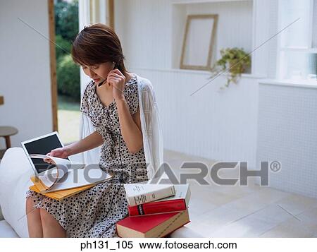Asian woman wearing a headset View Large Photo Image Stock Photography - Asian woman wearing a headset. Fotosearch