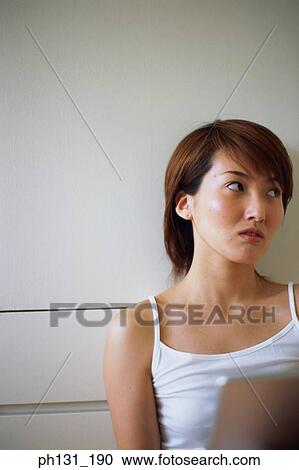 Asian Woman working on a laptop View Large Photo Image Stock Image - Asian Woman working on a laptop. Fotosearch