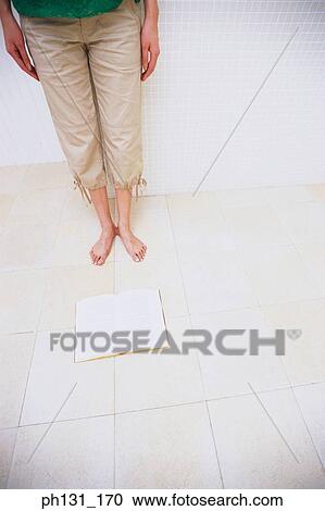 Book lying open next to a pair of feet View Large Photo Image Stock Image - Book lying open next to a pair of feet. Fotosearch