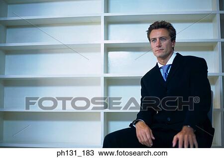 Stock Image - Caucasian man sitting in an empty office. Fotosearch