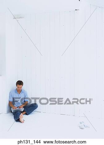 Caucasian man working on a laptop View Large Photo Image Picture - Caucasian man working on a laptop. Fotosearch