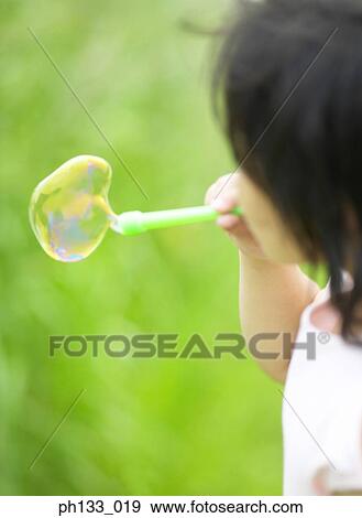 Child blowing bubbles View Large Photo Image Stock Photo - Child blowing bubbles. Fotosearch