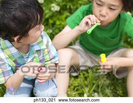 Children blowing bubbles View Large Photo Image Stock Image - Children blowing bubbles. Fotosearch