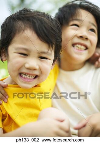 Children holding each other and smiling View Large Photo Image Stock Image - Children holding each other and smiling. Fotosearch