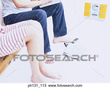 Stock Image - Male and Female legs. Fotosearch