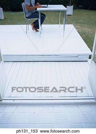 Stock Image - Man using a laptop. Fotosearch