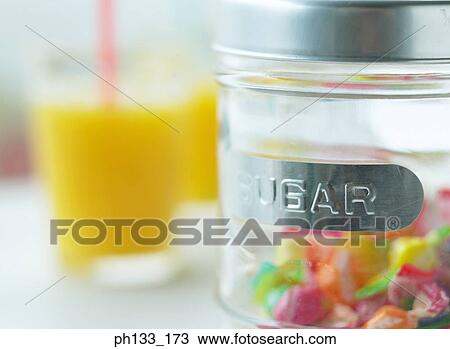 Two glasses of orange juice and sugar jar with candy View Large Photo Image Stock Image - Two glasses of orange juice and sugar jar with candy. Fotosearch