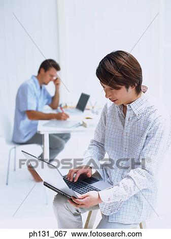 Two men working together View Large Photo Image Stock Photo - Two men working together. Fotosearch