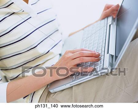 Woman fingers on a laptop keyboard View Large Photo Image Stock Image - Woman fingers on a laptop keyboard. Fotosearch