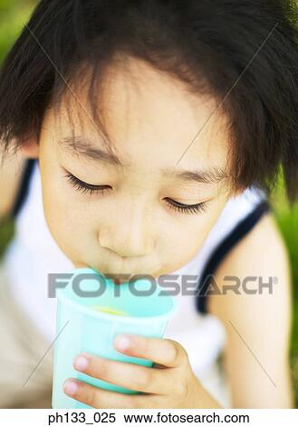 Young boy drinking from plastic cup View Large Photo Image Stock Photography - Young boy drinking from plastic cup. Fotosearch