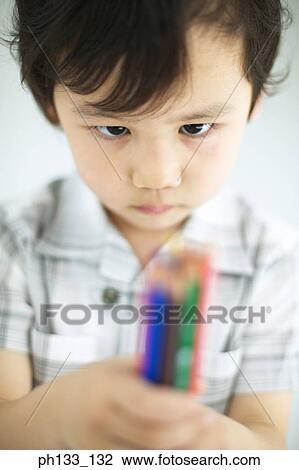 Young boy holding color pencils View Large Photo Image Stock Image - Young boy holding color pencils. Fotosearch