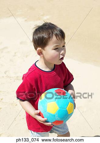 Young boy holding football View Large Photo Image Picture - Young boy holding football. Fotosearch