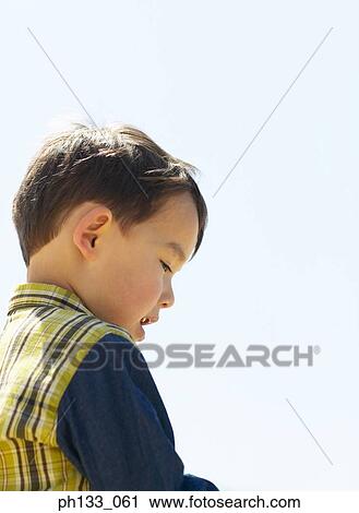 Young boy looking down View Large Photo Image Stock Image - Young boy looking down. Fotosearch