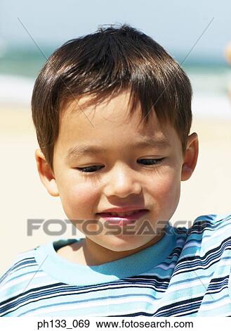 Stock Photo - Young boy looking & smiling. Fotosearch