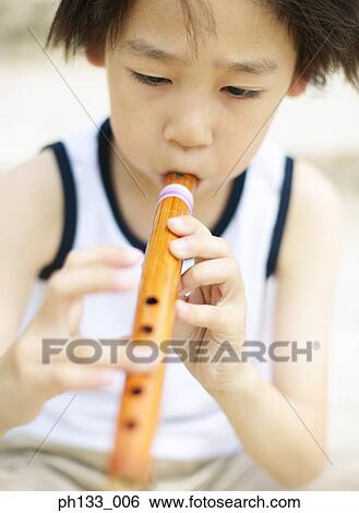Young boy playing flute View Large Photo Image Stock Photograph - Young boy playing flute. Fotosearch