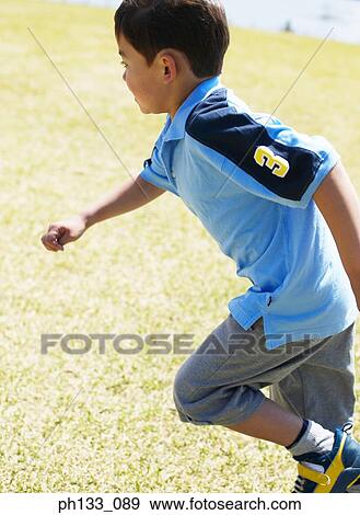 Stock Photo - Young boy running. Fotosearch