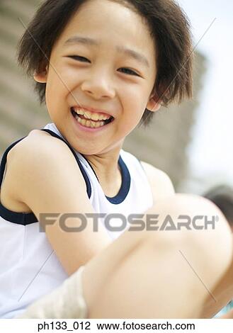 Young boy sitting & smiling View Large Photo Image Stock Image - Young boy sitting & smiling. Fotosearch