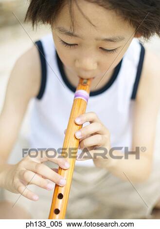 Young Child playing flute View Large Photo Image Stock Photography - Young Child playing flute. Fotosearch