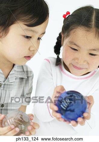 Young children holding glass balls View Large Photo Image Picture - Young children holding glass balls. Fotosearch