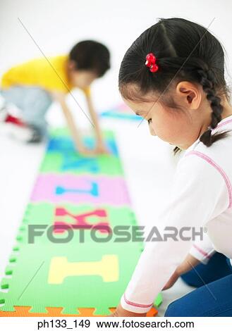 Young children playing jigsaw puzzle View Large Photo Image Stock Photo - Young children playing jigsaw puzzle. Fotosearch