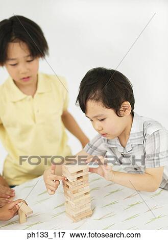 Young children playing with wooden building blocks View Large Photo Image Stock Photo - Young children playing with wooden building blocks. Fotosearch