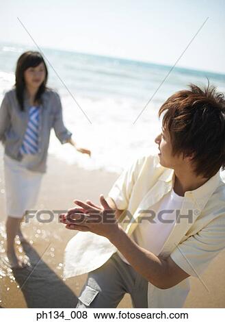 Young couple at beach View Large Photo Image Stock Photo - Young couple at beach. Fotosearch