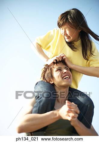 Young couple having fun View Large Photo Image Stock Image - Young couple having fun. Fotosearch