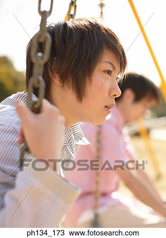 Young couple on swing View Large Photo Image Stock Image - Young couple on swing. Fotosearch