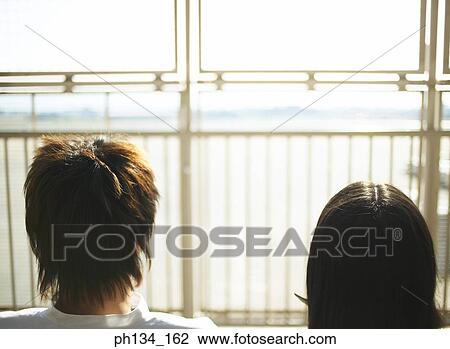 Stock Image - Young couple sitting together. Fotosearch