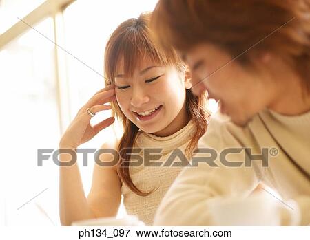 Young couple sitting together View Large Photo Image Stock Photo - Young couple sitting together. Fotosearch
