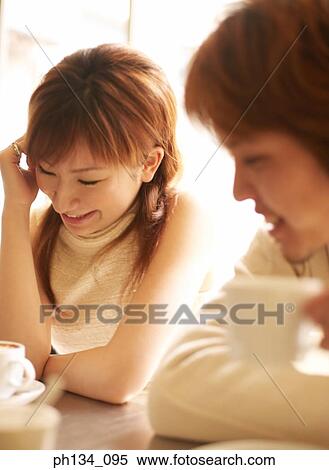 Stock Photography - Young couple sitting together. Fotosearch
