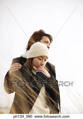 Young couple standing together View Large Photo Image Stock Image - Young couple standing together. Fotosearch