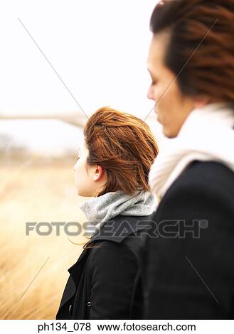 Stock Photo - Young couple standing together. Fotosearch