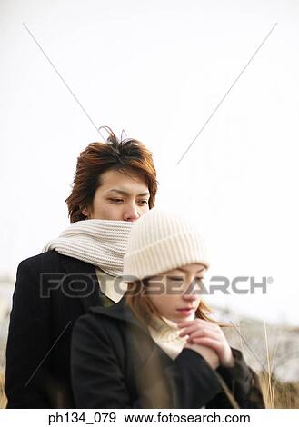 Stock Photo - Young couple standing together. Fotosearch