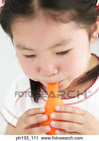 Young girl blowing a balloon View Large Photo Image Stock Image - Young girl blowing a balloon. Fotosearch