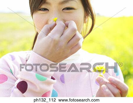 Young girl holding flower View Large Photo Image Stock Image - Young girl holding flower. Fotosearch
