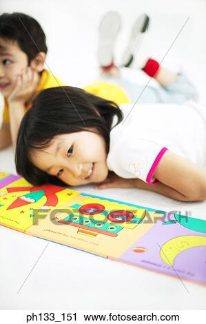 Young girl lying on floor View Large Photo Image Stock Image - Young girl lying on floor. Fotosearch