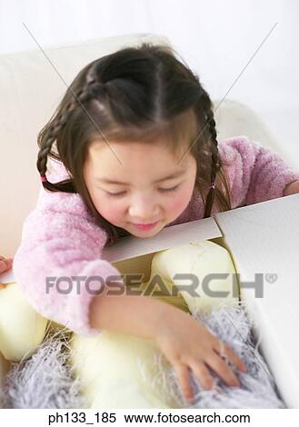 Young girl opening gift View Large Photo Image Stock Photography - Young girl opening gift. Fotosearch