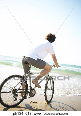 Young man at shore View Large Photo Image Stock Photo - Young man at shore. Fotosearch