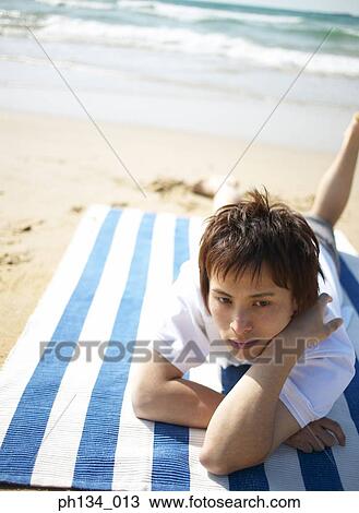 Stock Image - Young man at the beach. Fotosearch