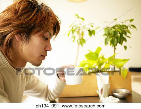Young man drinking coffee View Large Photo Image Stock Image - Young man drinking coffee. Fotosearch