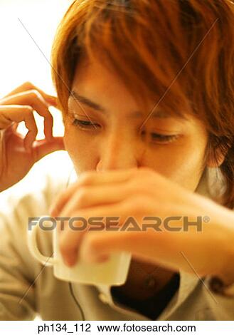 Stock Image - Young man drinking. Fotosearch