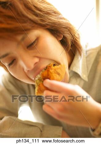 Young man eating View Large Photo Image Stock Image - Young man eating. Fotosearch