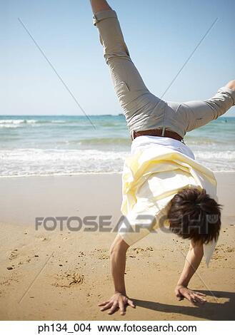 Young man exercising on the beach View Large Photo Image Picture - Young man exercising on the beach. Fotosearch