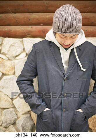 Young man looking down View Large Photo Image Stock Image - Young man looking down. Fotosearch