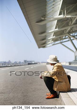 Young man sitting and waiting View Large Photo Image Picture - Young man sitting and waiting. Fotosearch