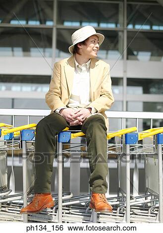 Young man sitting and waiting View Large Photo Image Stock Photograph - Young man sitting and waiting. Fotosearch